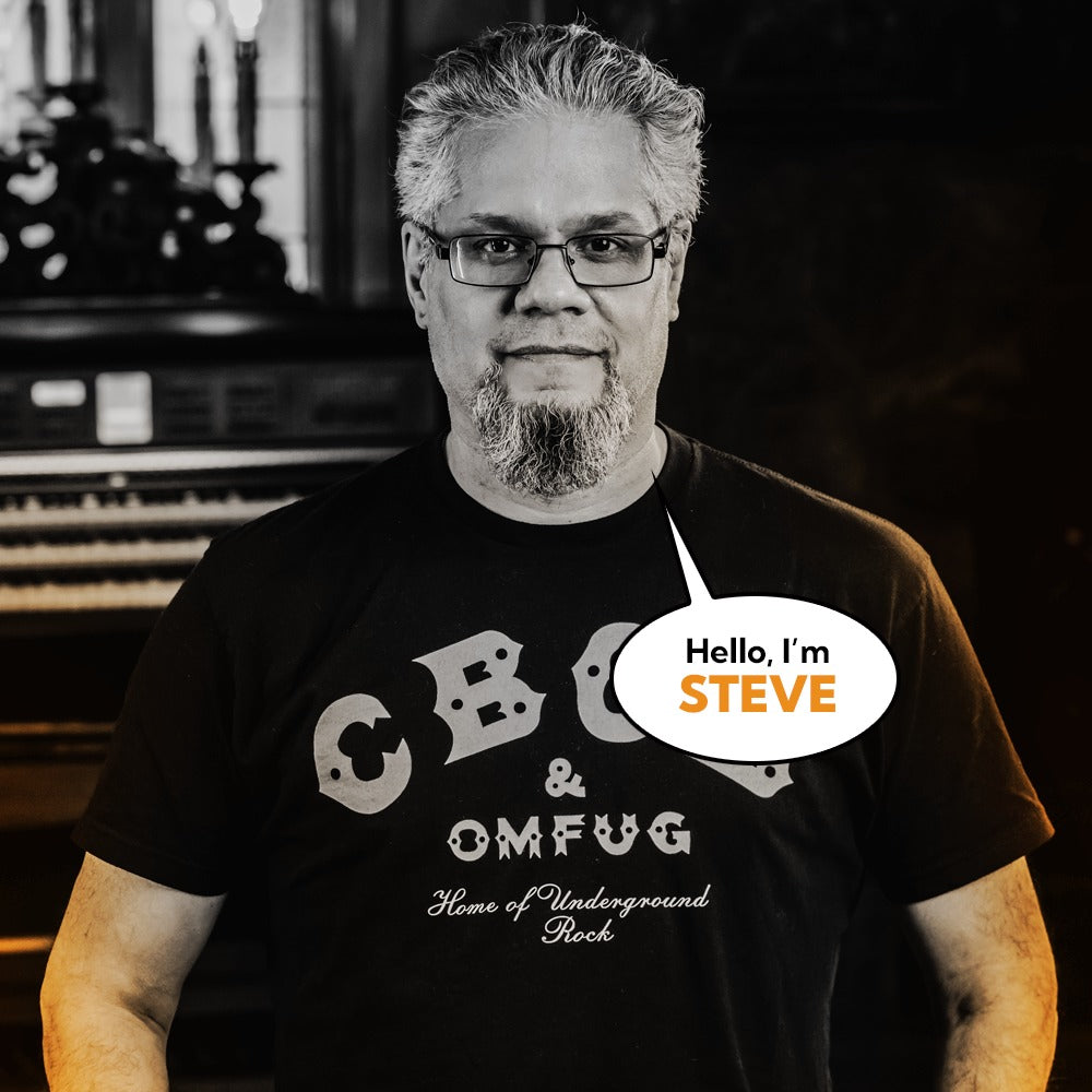 Steve Crespo, Studio Art Director at Corvus Comics, casually smiling in portrait wearing a graphic tee.